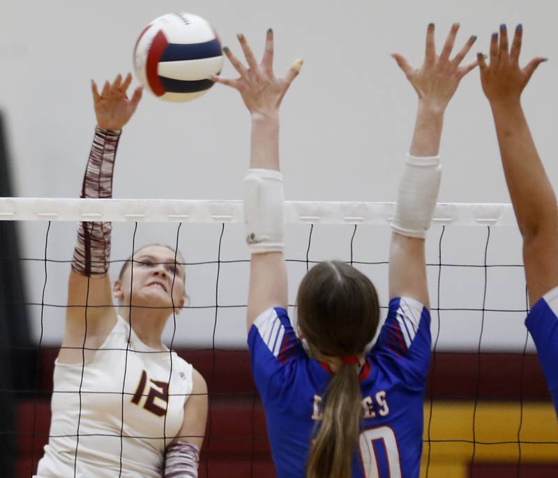 Richmond-Burton's Zoe Freund tries to hit the ball through the block of Lakes’ Isabel Stauber during a nonconference volleyball match on Monday, Sept. 29, 2025, at the Richmond-Burton High School in Richmond.