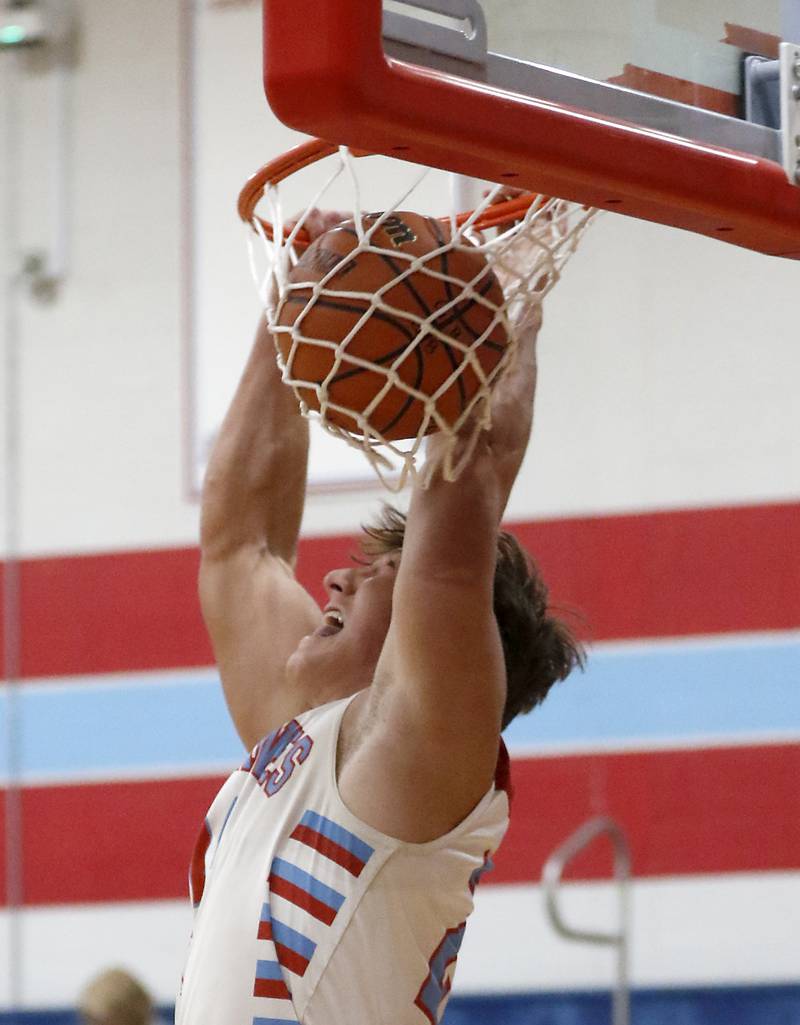 Marian Central’s Christian Bentancur dunks the basketball as he scores his 2,000 career point during a nononference boys basketball game against Marengo on Tuesday, Feb.13, 2024, at Marian Central High School.