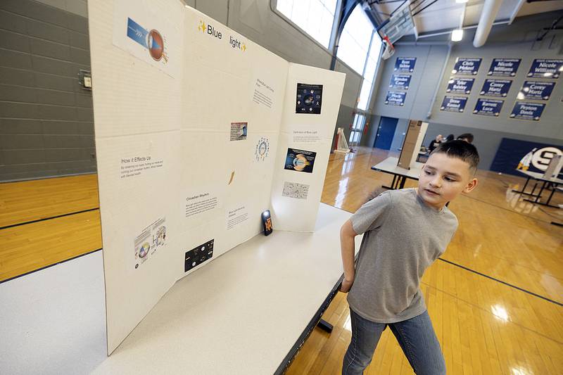 Nikko Bourgeois presents his research on blue light and its effect of health Thursday, March 6, 2025, at Challand Middle School. Sixth graders at the school were part of the third annual STEM Fair where they would research and use visual materials to present their findings on a topic.