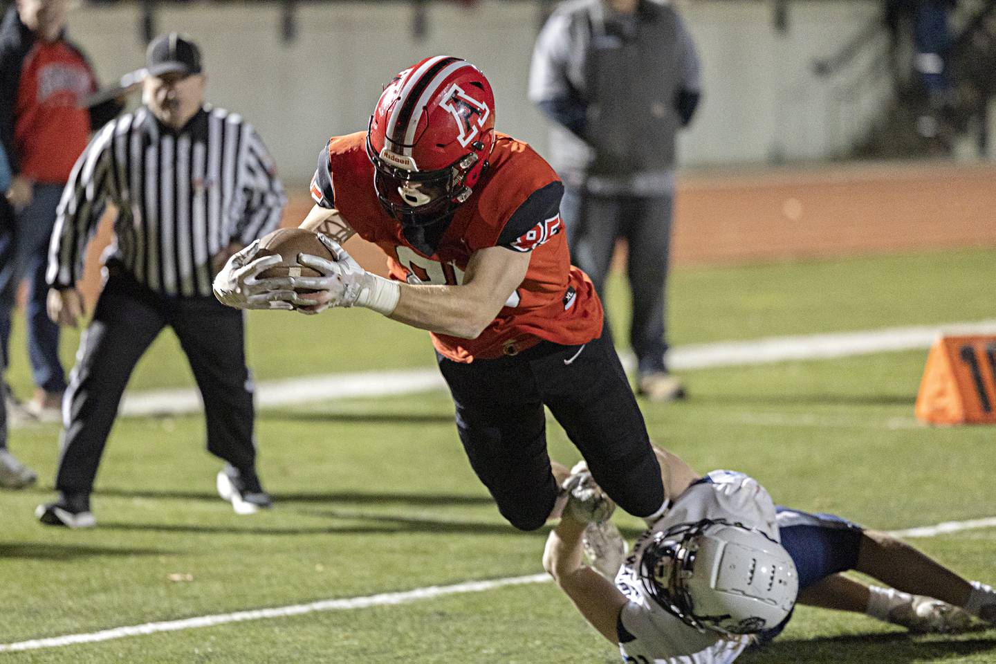 Amboy’s Brennan Blaine dives into the end zone against Ridgewood for a TD during the I8FA championship Friday, Nov.17, 2023 at Monmouth College