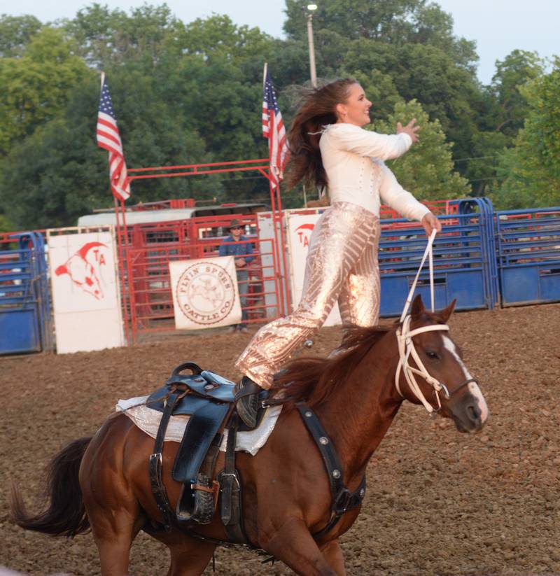 Trick rider Saige McNeill performs with the T & A Bucking Bulls Rodeo at the Ogle County Fair on Friday, Aug. 1, 2025 in Oregon.