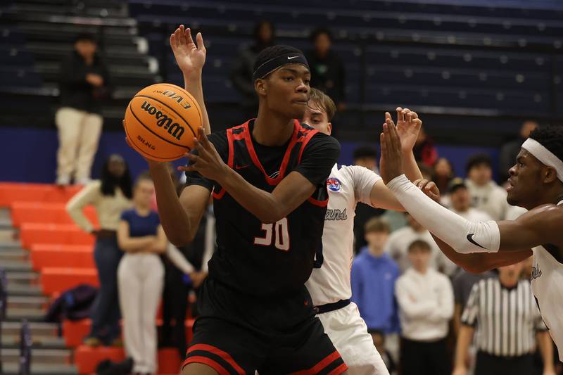 Bolingbrook's Jayden Madden looks to pass against Romeoville on Tuesday, Dec. 2, 2025 in Romeoville.