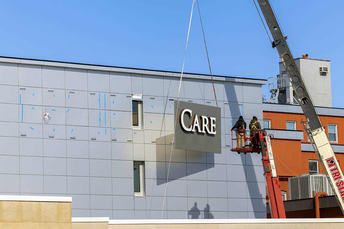 A new main sign is hoisted into place Tuesday, Feb. 18, 2025 at the hospital in Dixon. The care center has been rebranded OSF Saint Katharine Medical Center to pay tribute to the former KSB Hospital in Dixon.