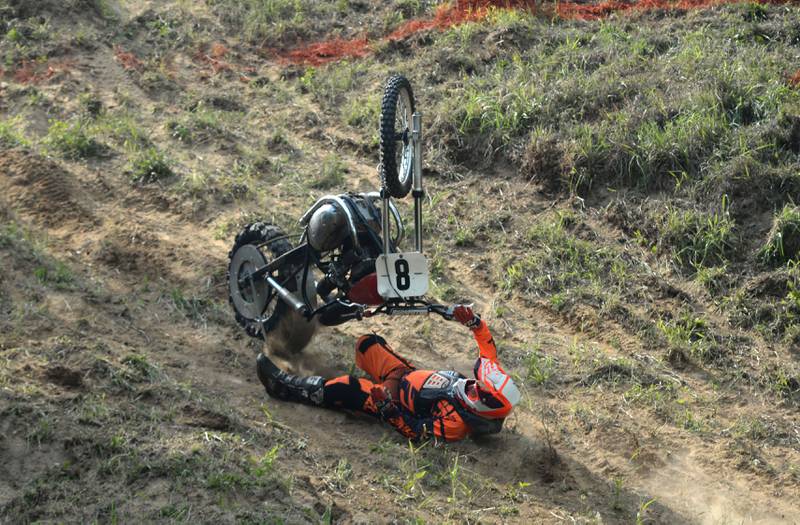 Wade Schultz of Lisbon, Iowa, falls on his back after flipping his motorcycle in one of his runs at the Rock River Riders Motorcycle Club's hillclimb on Sunday, Aug. 3, 2025. Schultz recovered to make other runs later in the day.