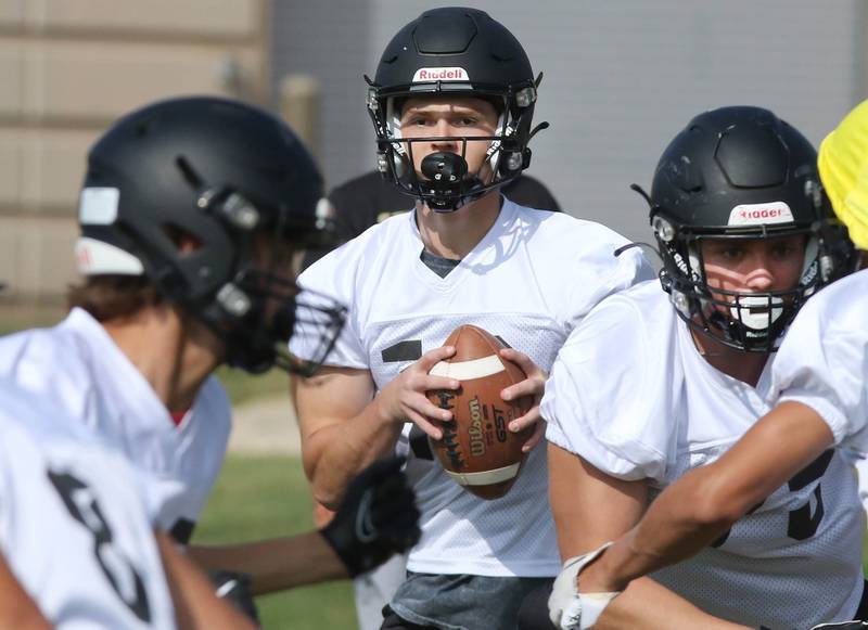 Sycamore quarterback Burke Gautcher drops back to pass during practice Monday, Aug. 7, 2023, at Sycamore High School.