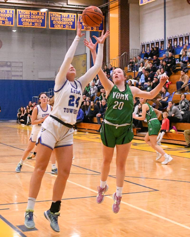 Lyons Township Kennedy Wanless (24)  and York Hannah Meyers (20) go up for a loose ball during the first quarter Friday Feb. 3rd held at Lyons Township High School.