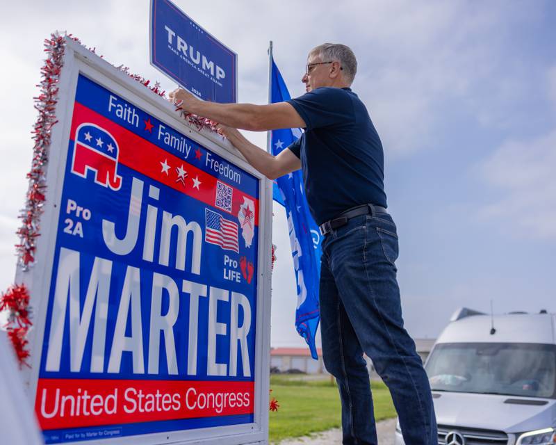 Jim Marter attaches his secures his campaign sign in the back of his truck prior to the Trump Birthday and Flag Day Caravan and Rally on June 14, 2025 at Jamie's Outpost in Utica.