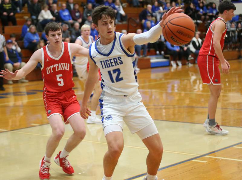 Princeton's Tyson Phillips reaches out to grab a rebound over Ottawa's Kyler Araujo on Monday, Feb. 5, 2024 at Prouty Gym.