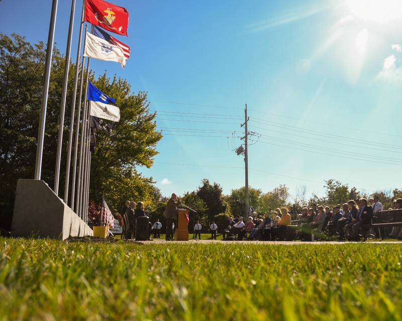 A crowd watches as speakers give remarks during a dedication ceremony marking the completion of phase one of the DeKalb Elks Veteran’s Memorial Plaza in DeKalb Saturday, Oct. 1, 2022.