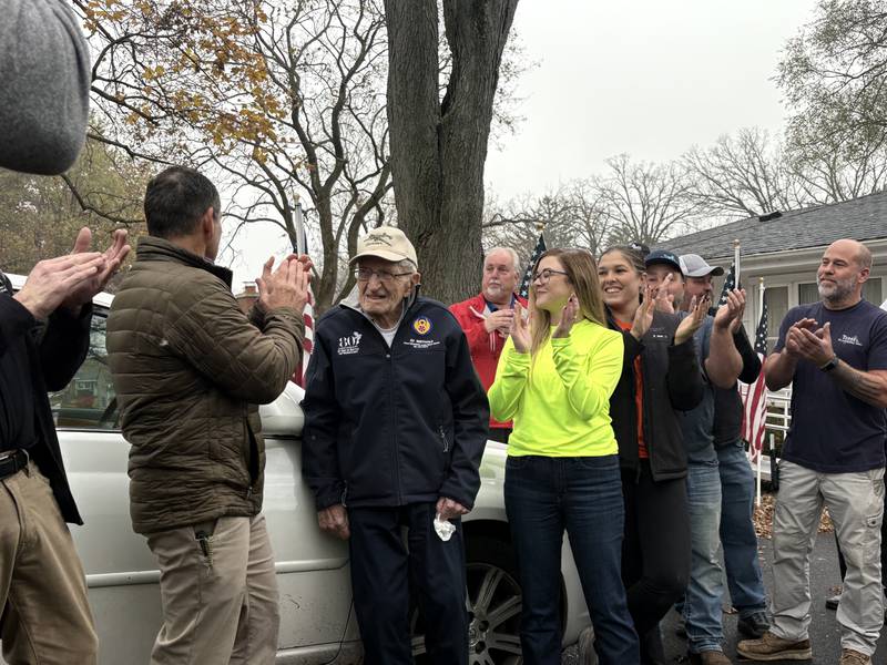 Individuals and contractors who helped renovate World War II veteran Ed Berthold's home to be more accessible sing him "Happy Birthday" on his 106th birthday.