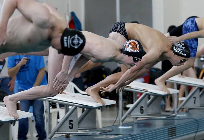 McHenry’s Robbie Rosenbaum dives into the pool as he competes in the 100 Freestyle during the Fox Valley Conference Invitational swim meet on Saturday,  Feb. 15, 2025, at Woodstock North High School.