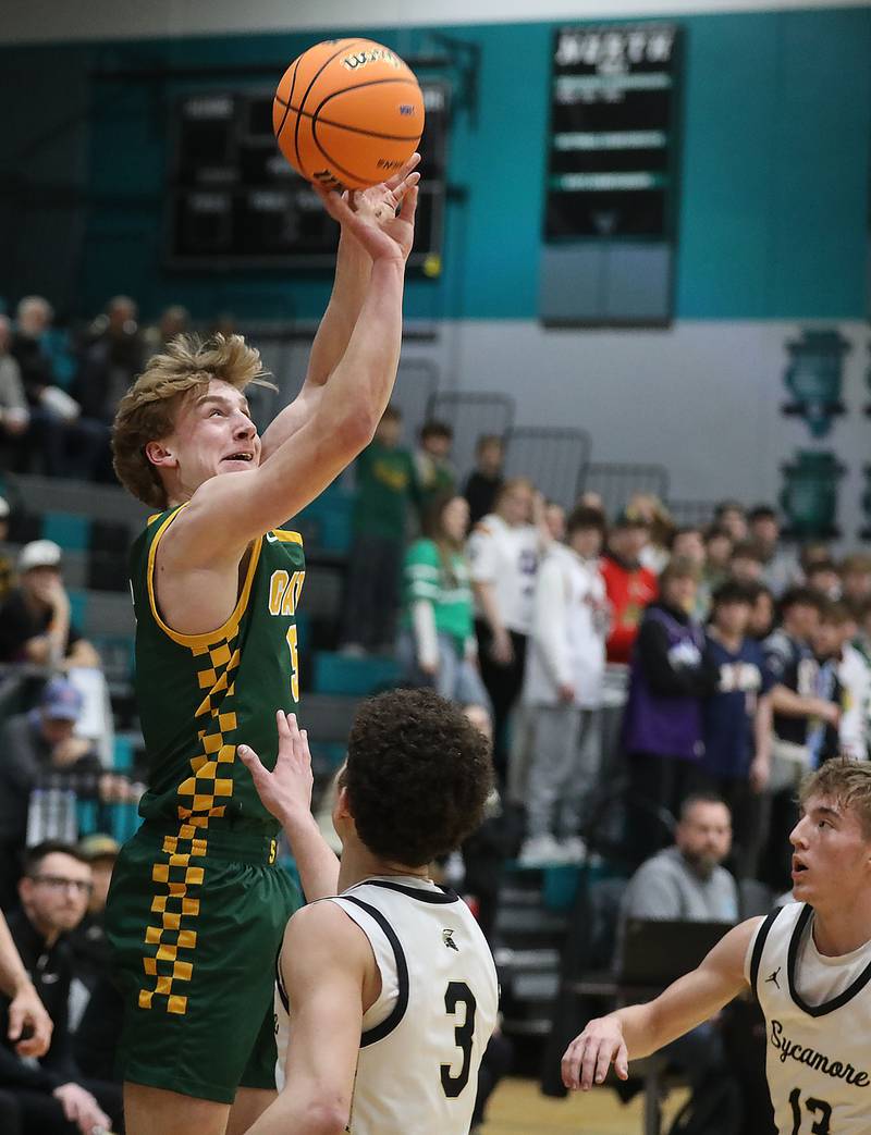 Crystal Lake South's Carson Trivellini shoots the ball over Sycamore's Marcus Johnson during an IHSA Class 3A Woodstock North Sectional semifinal.basketball game on Wednesday, March 4, 2025, at Woodstock North High School.