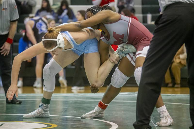 Teagan Aurich of Plainfield South High School (blue) wrestles undefeated Maryam Ndiaye of Moline High School in the 155 weight class during IHSA girls sectionals on February 10, 2024 at Geneseo High School.