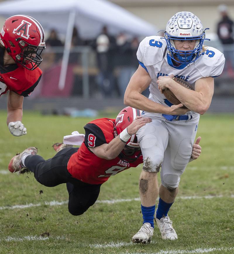 Martinsville’s Adam Parcel is held on to by Amboy’s Brody Christofferson Saturday, Nov. 9, 2024, in round two of the 8-man football playoffs.