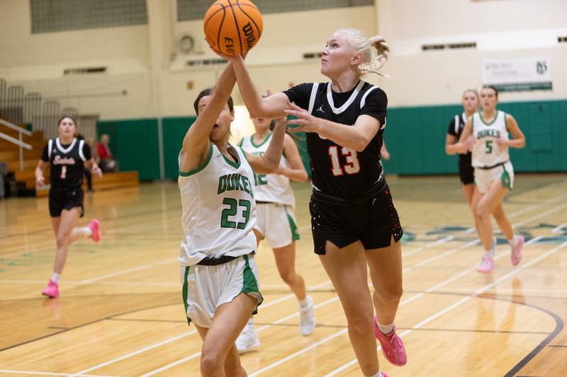 St. Charles East's Addie Schilb goes in for a layup against York's Kayla Callahan at the York Girl's Thanksgiving Tournament on Tuesday, Nov. 18,2025 in Elmhurst.