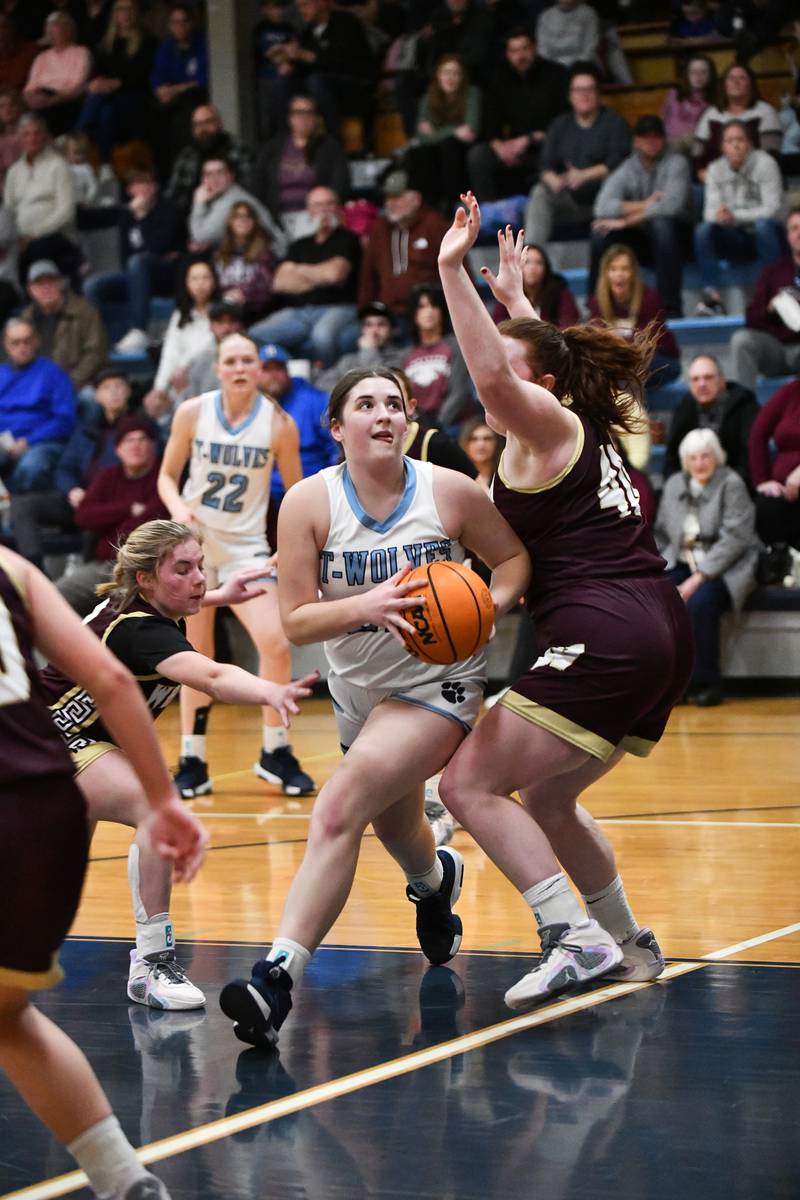 Cissna Park's Lauryn Hamrick evades Watseka-Milford defenders for a layup Monday, Feb. 10, 2025, during the Timberwolves' 61-40 victory.