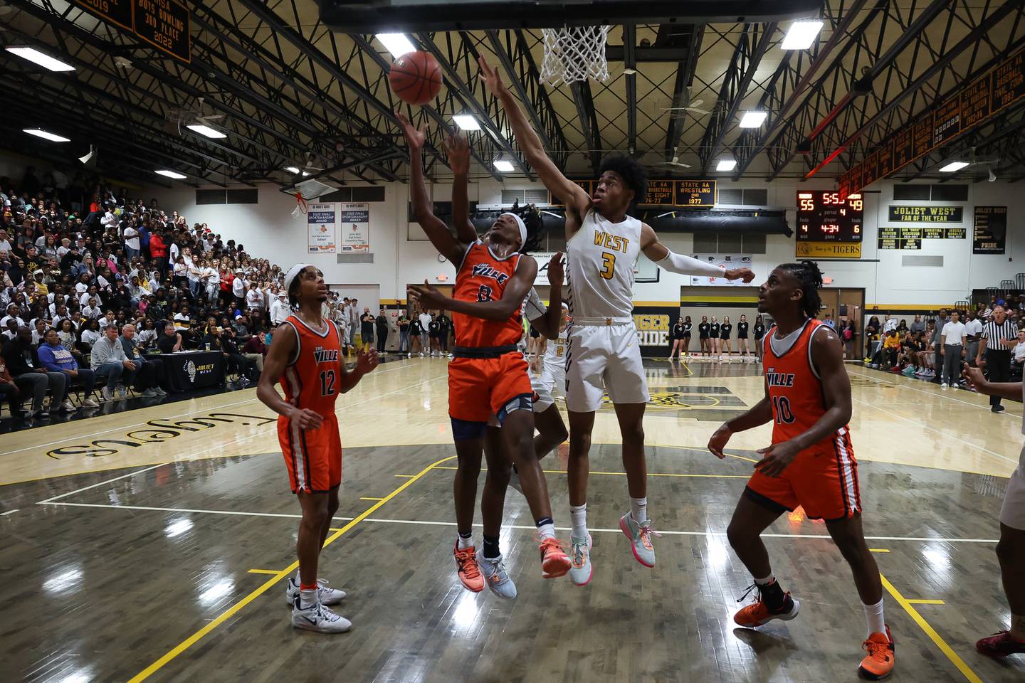 Romeoville’s TJ Lee (0) lays in a shot and draws the foul from Joliet West's Matthew Moore (3) on Friday, Dec. 2, 2022.
