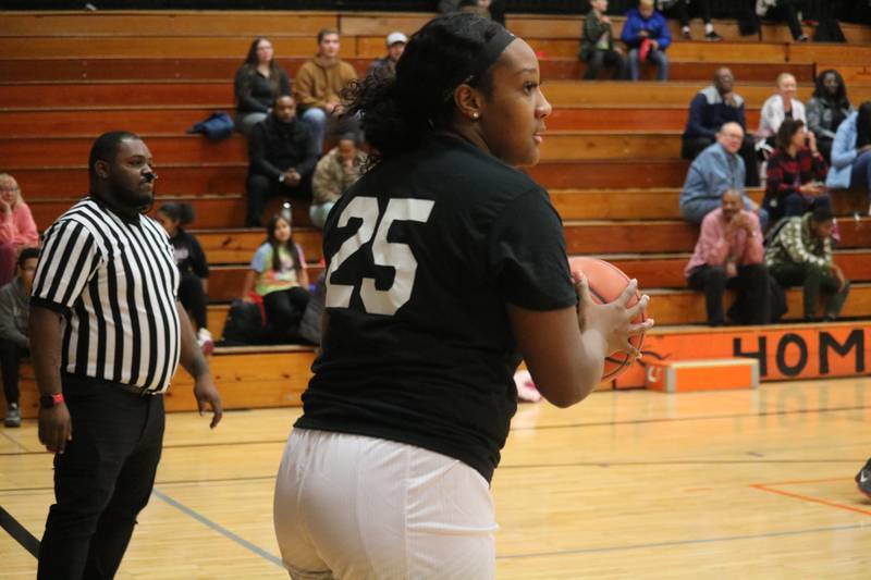 A'Jah Davis (right) inbounds the ball from the sideline Monday, Dec. 5, 2022 in the Toys for Tots community basketball game.