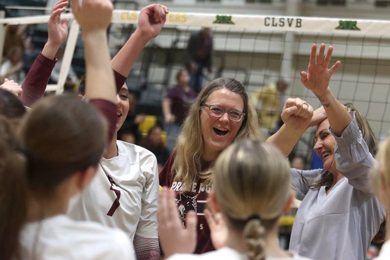 Prairie Ridge’s coaches and players celebrate a win over Woodstock North in IHSA Class 3A Sectional semifinal volleyball action on Tuesday, Nov. 5, 2024, at  Crystal Lake South High School  in Crystal Lake.