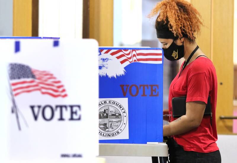 Peyton Greene votes Tuesday at the polling place inside the Westminster Presbyterian Church on Annie Glidden Road in DeKalb.