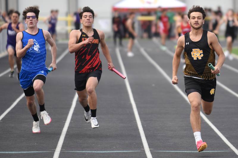 Reed-Custer's Jesse Tresouthick, right, leads Peotone's Tyler Walker, left, and St. Anne's Gavin Threm to the finish line of the 4x100 m relay at the Herscher Invite Friday, May 2, 2025.