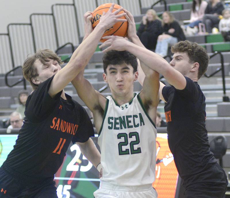 Seneca’s Brayden Simek finds his shot blocked by Sandwich’s Nick Michalek and Griffin Somolock  in the 2nd period Saturday during the MLK Shootout at Seneca.