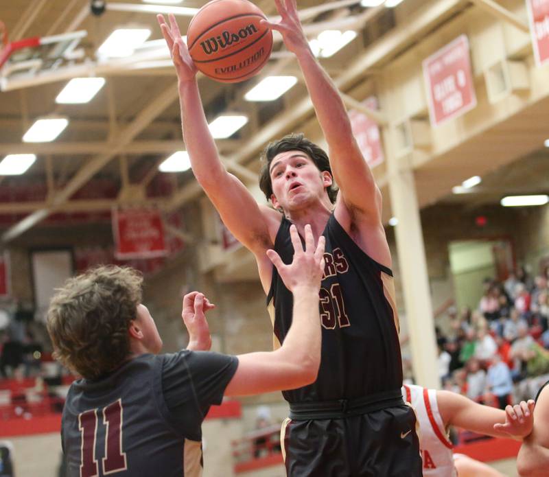 Morris's Carter Landeman grabs a rebound with the help of teammate Joey Vinachi against Ottawa on Wednesday, Jan. 3, 2024 at Kingman Gym.