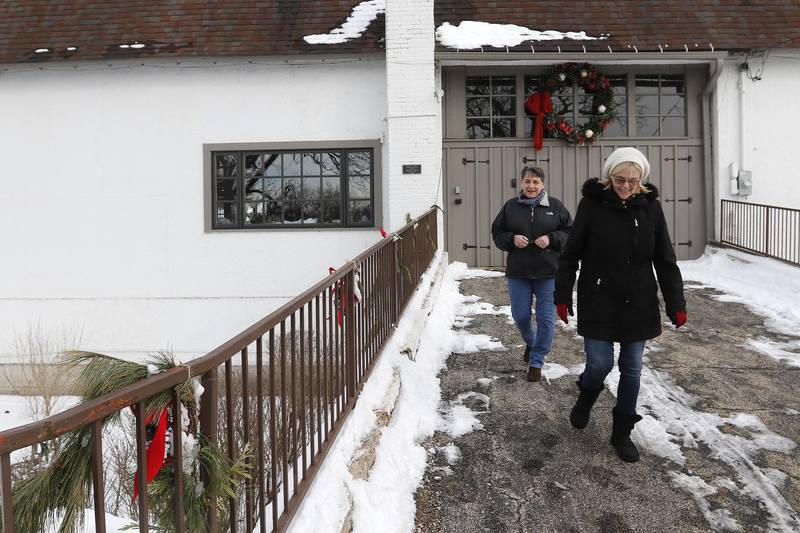Linda Stelle, left, and Kristin Purtill head out of the horse barn on Tuesday, Jan. 4, 2022 in the Village of Trout Valley.