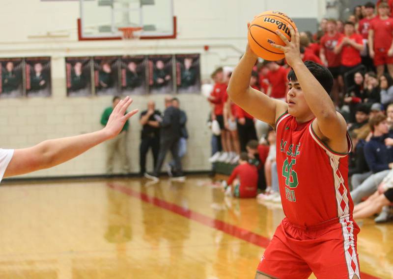 L-P's Andy Medina looks to pass the ball around a Dixon defender during the Class 3A Regional semifinal game on Wednesday, Feb. 26, 2025 in Sellett Gymnasium at L-P High School.
