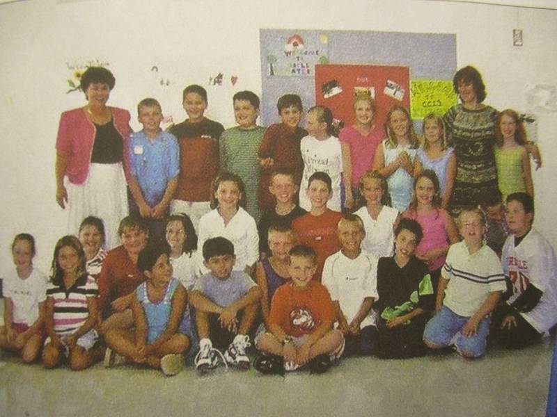 Julie O'Connor, right, visits with Elaine Mroczka and her Circle Center Grade School students in August of 2002, in a photo from their new book "United States of Friendship: Pen Pals of 9/11" (Mark Foster -- mfoster@shawmedia.com)