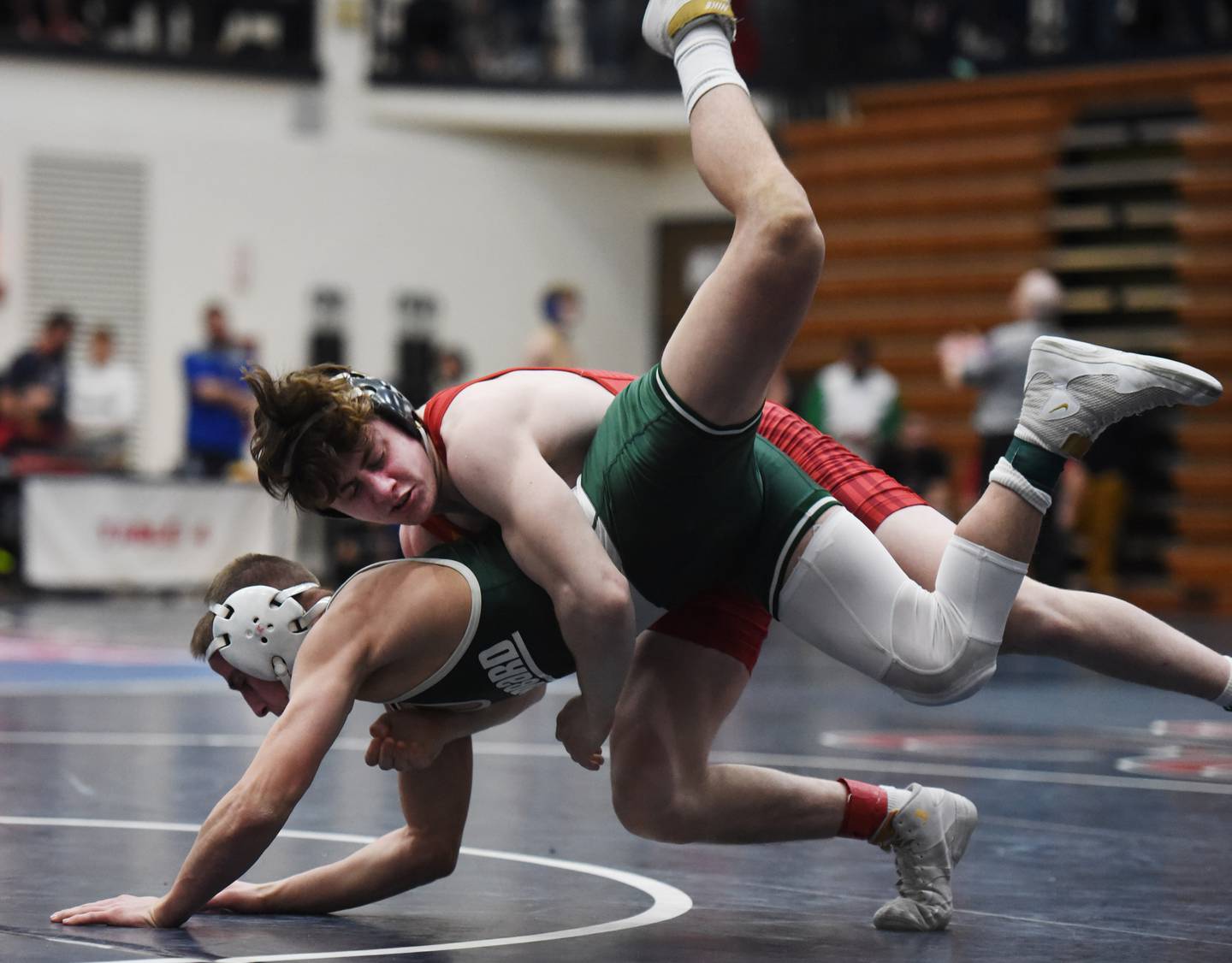 Batavia’s Kaden Fetteroff, top, takes down Glenbard West’s Jacob Lachs in a 138-pound match during the semifinals of the Conant wrestling sectional in Hoffman Estates Saturday.