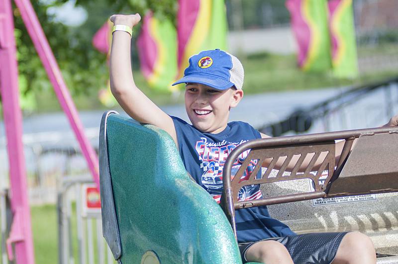 Carter Farias, 10, of Dixon rides the Scrambler Thursday, June 30, 2022 at Dixon’s Petunia Fest.