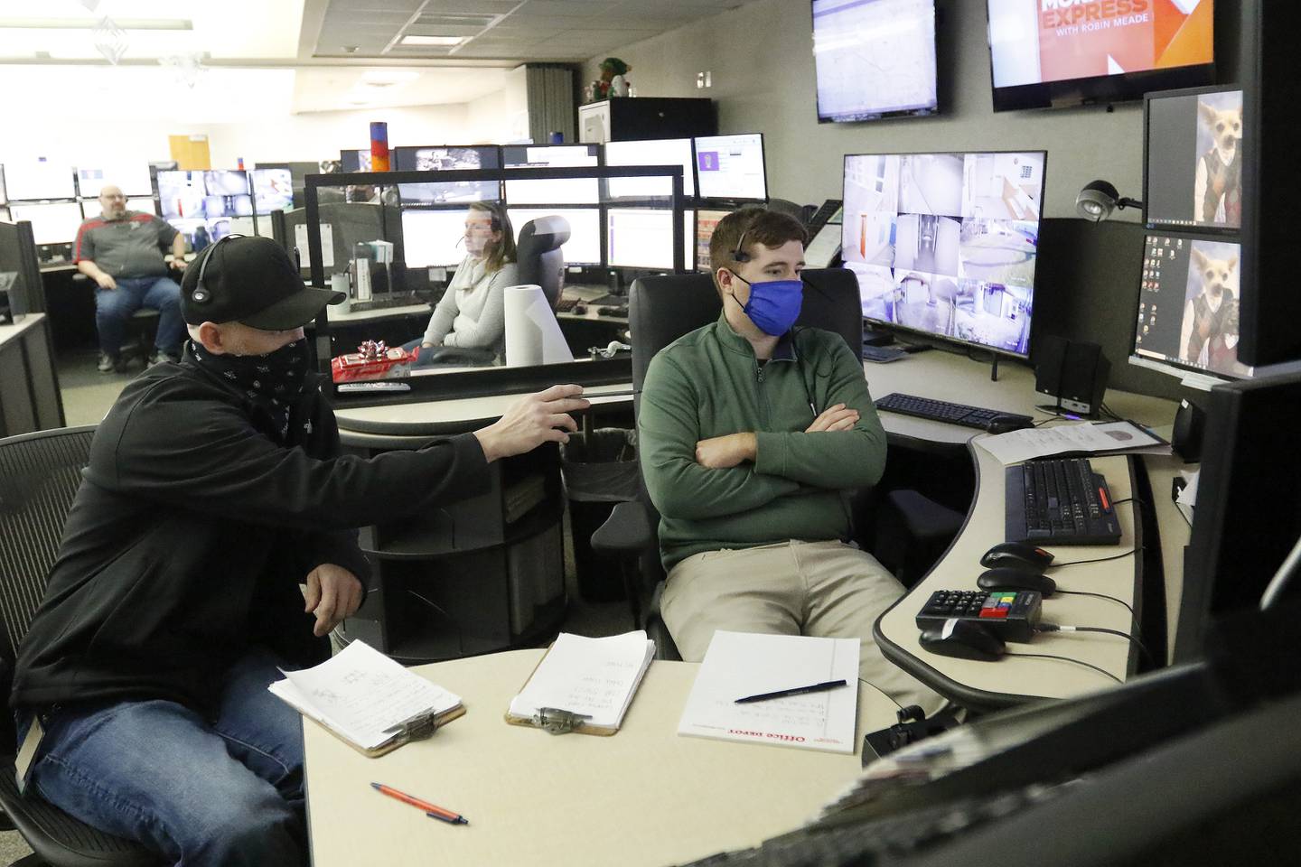 SEECOM telecommunicator trainer Mike Jurkowski, left, works with Jim Epley on the phones and computer systems that connect 911 calls to first responders on Wednesday, Dec. 22, 2021, at Aaron T. Shepley City Hall in Crystal Lake.