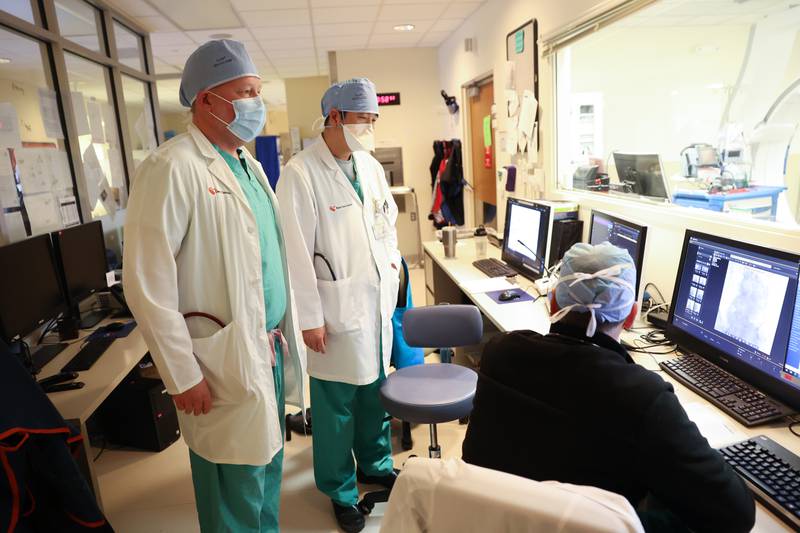Dr. Christopher Bane, left, and Dr. Hong Jun Yun go over images of a patient with a technician at Silver Cross Hospital. Shockwave IVL is relatively new technology that uses shock waves to break up kidney stones and other calculuses while leaving soft tissue undisturbed. Monday, April 25, 2022, in New Lenox.