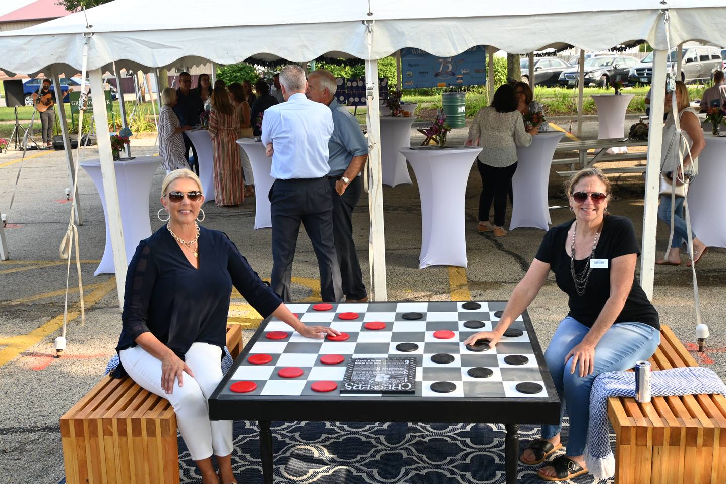 Illinois Sen. Sue Rezin, R-Morris and Nancy Norton, President of the Grundy County Economic Council enjoy a game of checkers during Grundy County Chamber's 75th anniversary event 'Jewels and Jeans.'