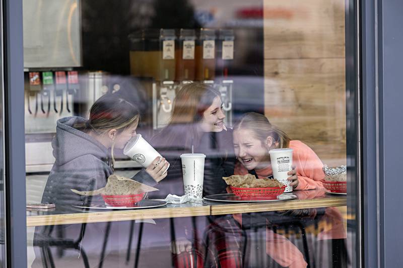 Lillian Sitter (left), Johanna Lindstrom and Emma Nicklaus enjoy their first stop at the newly opened Dixon Chipotle Friday, Dec. 29, 2023. “It’s awesome,” they exclaimed about the day.