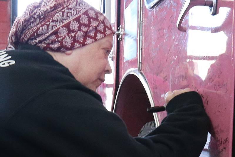Rachel Sienkiewicz signs the Pink Heals Firetruck on Thursday, Feb. 13, 2025 at the Peru Fire Station. Sienkiewicz is a telecommuicator at the Illinois Valley Regional Dispatch Center in Peru, who is battling uterine cancer. The Pink Heals Sauk Valley Chapter is a non profit providing communities with a program that supports people on a personal level in partnership with the public safety and local businesses.