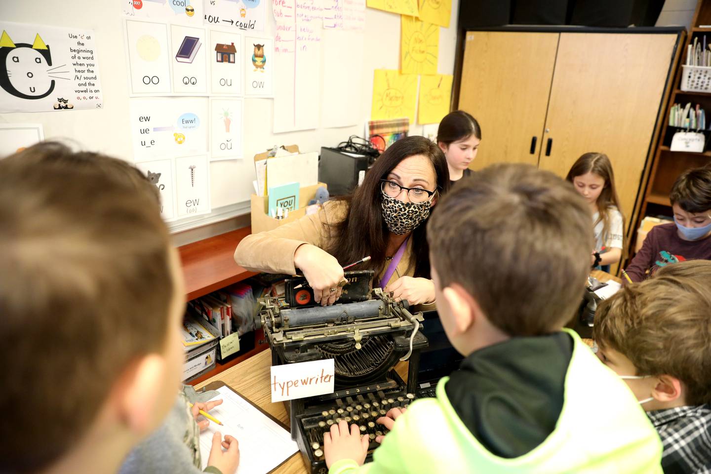 Munhall Elementary School second grade teacher Amy Fronk and her students examine historic relics such as a typewriter and rotary telephone and compared them to the present-day equivalent of a laptop computer and cellular phone. Fronk grew up in St. Charles and attended Munhall as a student.