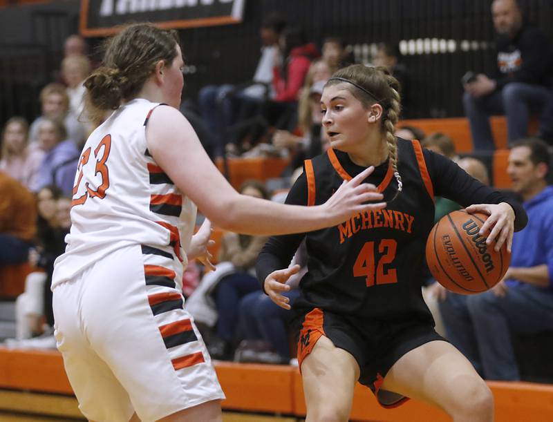 McHenry's Madalynn Friedle, right, brings the ball up the court against Crystal Lake Central's Leah Spychala, left, during a Fox Valley Conference girls basketball game Tuesday, Nov.. 29, 2022, between Crystal Lake Central and McHenry at Crystal Lake Central High School.