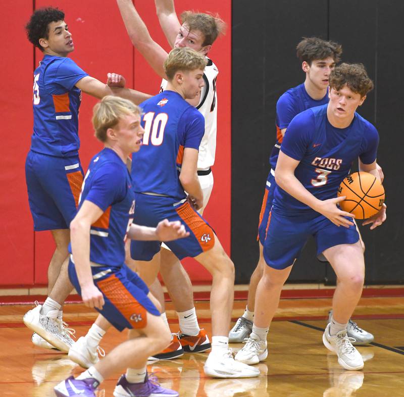 Genoa-Kingston's Jack Peterson (3) comes up with the ball as he and his teammates collapse on Warren's Bryce VanRaalte (25) at the 64th Annual Forreston Holiday Basketball Tournament held at Forreston High School on Saturday, Dec. 13, 2025.