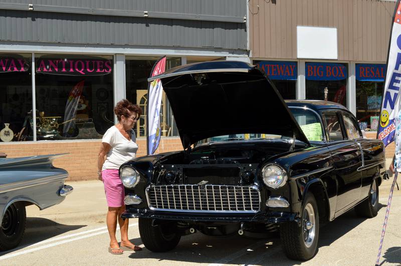 Jeanne Plumb, of Dixon, looks at a 1955 Chevrolet 210 owned by John Clothier, of Mt. Morris, during the 35th annual Polo Car Show on Saturday, Aug. 10, 2024.