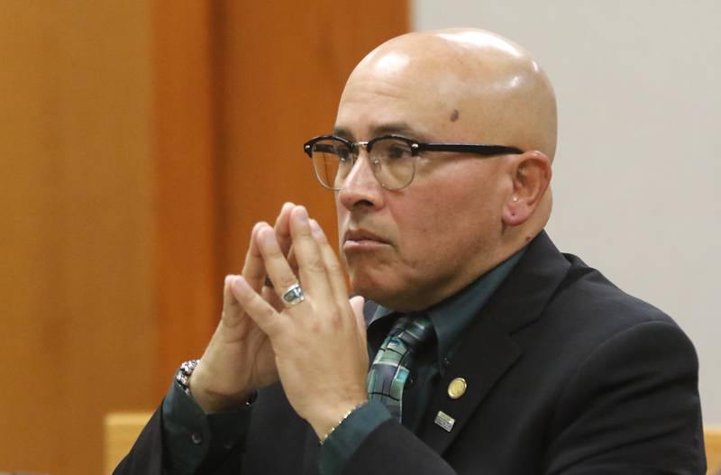 Carlos Acosta listens to McHenry County State's Assistant Attorney Randi Freeze as she delivers the state’s closing argument the during the trial for the former Illinois Department of Children and Family Services employees Acosta and Andrew Polovin before Lake County Judge George Strickland on Friday, Oct. 13, 2023, at the McHenry County Courthouse. Acosta, 57, of Woodstock, and Polovin, 51, of Island Lake, each are charged with two counts of endangering the life of a child and health of a minor, Class 3 felonies, and one count of reckless conduct, a Class 4 felony, related to their handling of the AJ Freund case.