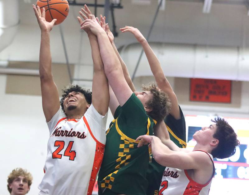 McHenry’s Adam Anwar, left, and Garet Lobbins, right, battle Crystal Lake South’s Johnathan Morgan for the ball  in varsity boys basketball on Friday, Feb. 20, 2026, at McHenry High School in McHenry.