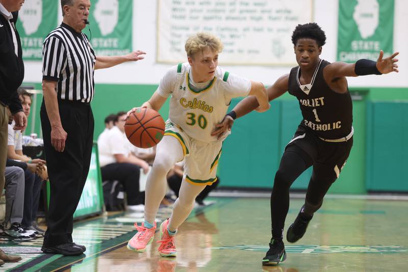 Providence’s Seth Cheney drives around Joliet Catholic’s Jayden Armstrong on Saturday, Dec. 9th, 2023 in New Lenox.