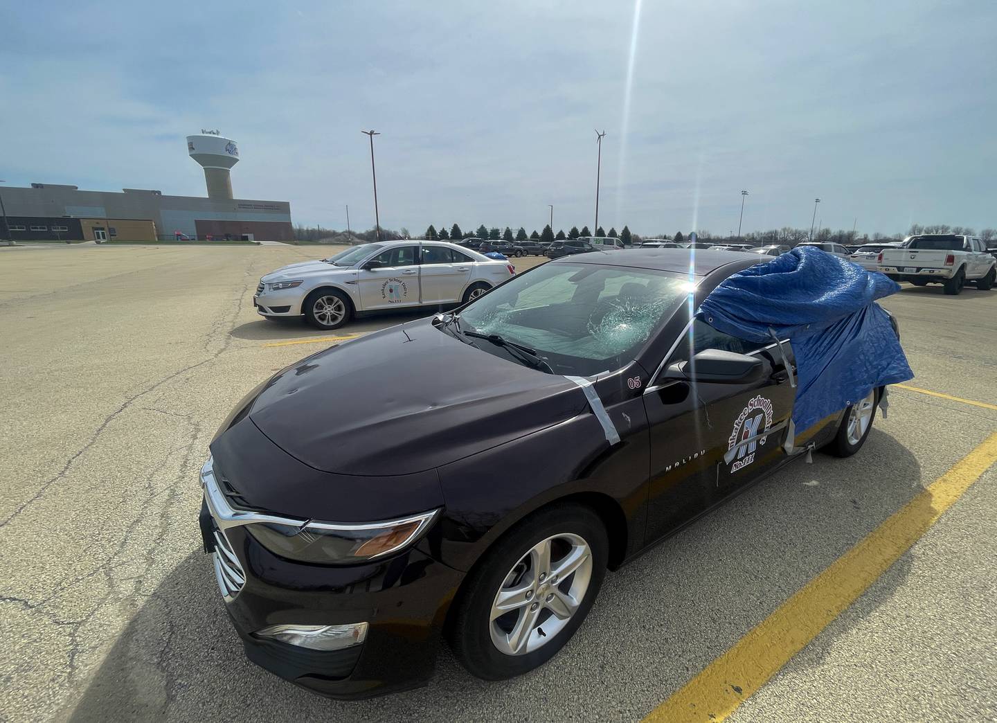 Kankakee School District driver education vehicles show significant damage following the March 10 storms, as seen on April 11, 2026, at Kankakee High School.