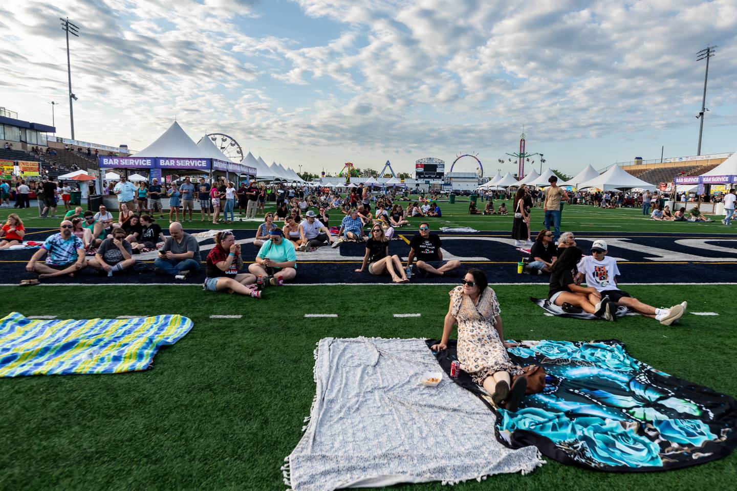 Taste of Joliet attendees enjoy the food and fun at Busey Bank Field at Joliet Memorial Stadium on June 20, 2025.