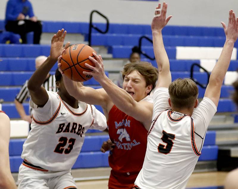 Marian Central's Christian Bentancur drives to the basket between DeKalb's Davon Grat and Tyler Vilet during a Central High School’s Dr. Martin Luther King, Jr., Boys Basketball Tournament game Friday, Jan. 13, 2023, at Central High School in Burlington.