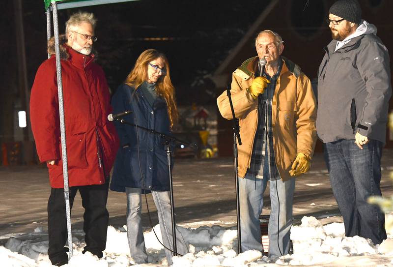 Bob Vogl, the husband of the late Sonia Vogl, speaks prior to the lighting of the Christmas tree at Oregon's Candlelight Walk on Saturday, Dec. 6, 2025. The tree was dedicated in memory of Vogl and stands with a sign that reads: "In memory of Sonia Vogl. Her generosity and dedication to our community has not gone unnoticed. Thank you for keeping our community 'lit up' over the past several years!"