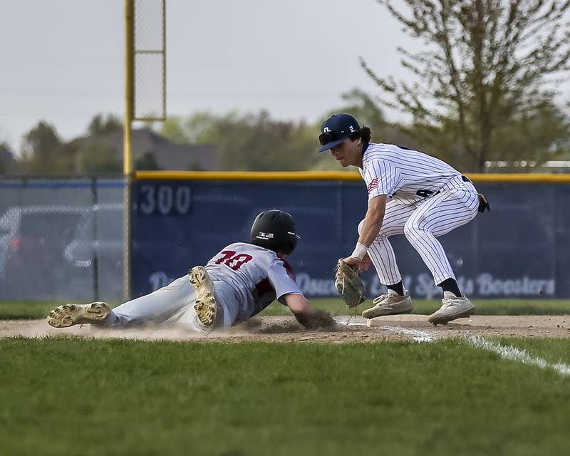Plainfield North's Brendan Henderson (10) dives back to third during baseball game between Plainfield North at Oswego East, Monday, April 28, 2025 in Oswego.