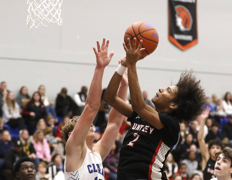 Huntley's Omare Segarra drives to the basket against Burlington Central's Jacob Johnson during a Fox Valley Conference boys basketball game on Friday, Dec. 15, 2023, at Burlington Central High School.